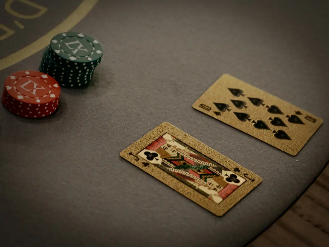 Playing cards on a grey felt table
