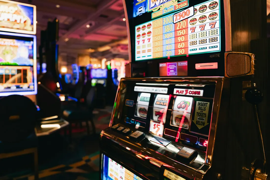 Slot machines in a dimly lit casino hall